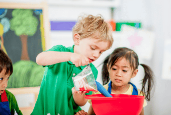 Two elementary aged children playing together in social skills program