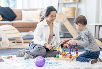 ABA therapist and elementary aged boy during in-home session